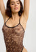 Front detail of the Sheer Mesh Leopard Bodysuit with scoop neckline and animal print, emphasizing the body-hugging transparent fit.