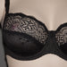 Close-up of Conturelle Belle De Jour black lace bra showcasing intricate floral lace design and structured underwire for luxurious full figure support.