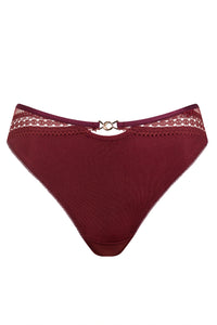 Close-up of lace and semi-sheer fabric on garnet red Brazilian panty