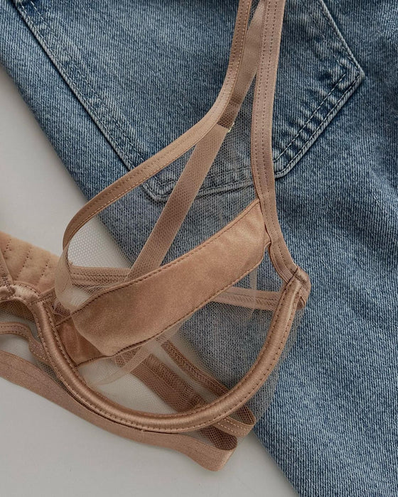 Flat lay of Kinga Nude Demi Cup Bra Lou on denim background, showing fine mesh details and soft fabric for stylish lingerie appeal.