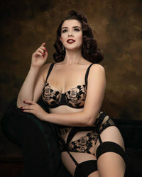 Elegant model in Dita Von Teese Rosabelle Underwire Balconette Bra Black posing in vintage-inspired setting with full lingerie set.