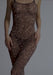 Dim-lit view of Mesh Maxi Dress Blush in leopard print emphasizing sheer stretch material and body-contouring design for nightwear fashion.