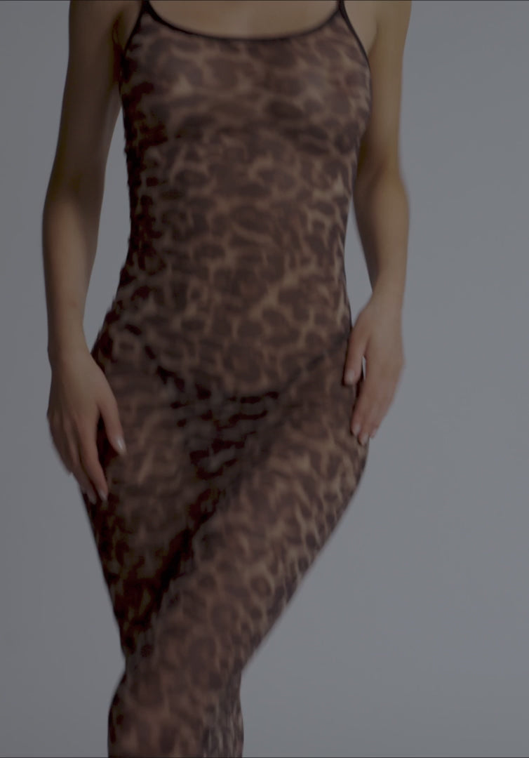 Dim-lit view of Mesh Maxi Dress Blush in leopard print emphasizing sheer stretch material and body-contouring design for nightwear fashion.
