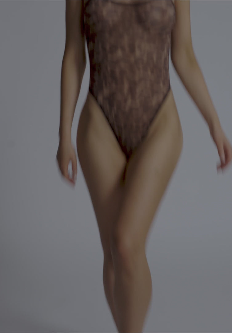 Blush Mesh Leopard Bodysuit in motion, highlighting the sheer stretch fabric and high-leg cut for a sexy lingerie look.