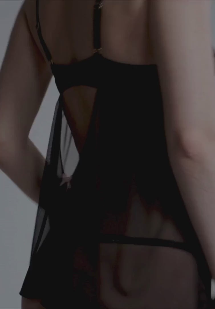 Motion shot of Sheer Scallop Babydoll Blush Lulu highlighting the airy flow of the sheer mesh fabric and elegant back design in loungewear.